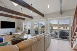 A wall of sliding glass doors opening up to the back deck