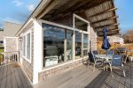 Private back deck with an outdoor dining table, umbrella, and grill 