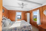 Primary bedroom with a queen bed and ocean views