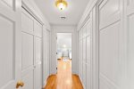 Hallway approaching the third bedroom with plenty of storage space in the closets