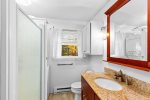 Bathroom with a stand up shower and washer / dryer