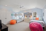 Bedroom located on upper level in separate wing, XL full-size bed over a queen bunkbed, a twin trundle, and a standalone full-size bed. 