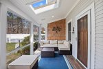 Sunroom with pool view and 40 TV. Lovely space to relax