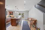 Bright, inviting kitchen with exterior access to pool and patio