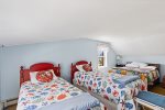 Upstairs bedroom with two twin beds and a full bed