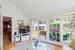 A bright and airy space with a TV and direct access to the back deck