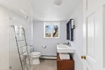 Modern, bright bathroom located on lower level
