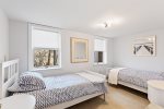 Bedroom located on lower level with two twin beds, perfect for families
