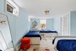 Bedroom located on lower lever with two twin beds, a double bed, and a twin trundle bed