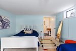 Bedroom located on lower lever with two twin beds, a double bed, and a twin trundle bed