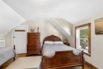 Cozy bedroom with full and twin beds in this Harwich vacation rental, ideal for small families