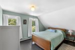 Comfortable second-floor queen bedroom in your Harwich vacation home, perfect for unwinding during your Cape Cod stay