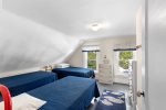 Family-friendly bedroom with three twin beds in this Harwich vacation rental, ideal for kids and young guests visiting Cape Cod