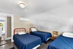 Bright and cheerful bedroom with three twin beds  perfect for kids or siblings during your family Cape Cod vacation in Harwich, MA