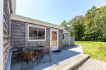 Outdoor dining on the side deck of this Harwich beach house rental, ideal for enjoying Cape Cod summer evenings