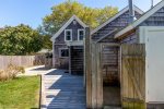 Backyard oasis featuring an outdoor shower, perfect for families and beach-goers visiting Harwich, MA