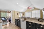 Enjoy effortless access from the kitchen to the screened-in porch  perfect for dining al fresco