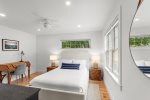 First floor bedroom with plush bedding and breezy Wellfleet coastal style.