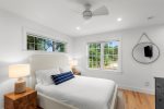 Cozy bedroom with hardwood floors and modern coastal finishes.