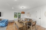 Bright open-concept living and dining room filled with Cape Cod natural light.