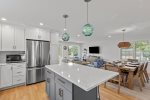 Modern kitchen featuring quartz countertops and crisp coastal cabinetry.