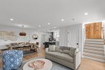 open first-floor living and dining area, showcasing its bright Cape Cod style.