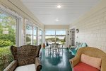 Charming porch with additional seating and dining options, perfect for al fresco meals or relaxing with a good book