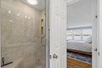 Spacious glass shower with modern finishes adds a touch of luxury to your stay