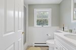 Third full bathroom on the second floor with a walk-in shower and bright, coastal dcor
