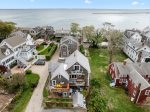 A stunning aerial view showcases this luxury Provincetown retreat overlooking the sparkling waters of Provincetown Harbor.