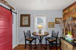 Intimate dining nook with a tall table and two chairsperfect for a quiet breakfast before heading out to explore downtown Provincetown.