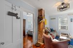View of the bedroom entrance just off the living room. This cozy Provincetown apartment offers an intimate and thoughtfully designed space.