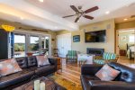 living area with comfortable seating and ceiling fan, perfect for games, movies, or quiet reading time.