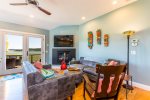 Bright second-floor kitchen and living area with water-facing windows, ideal central hub for Cape Cod family vacations in Wellfleet.