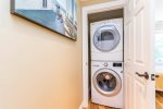 In-home laundry with stacked washer and dryer, a key amenity for week-long Cape Cod beach vacations.