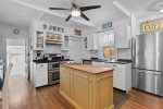 Kitchen island with barstool seating, perfect for morning coffee before heading to Centerville and Craigville area beaches.