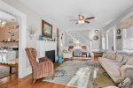 Bright first-floor living room with comfy seating and hardwood floors, a central gathering space for your Centerville Cape Cod getaway.