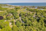 Aerial view showing generous lot, surrounding trees, and Centerville neighborhood location on Cape Cod.