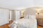 Natural light and soft coastal styling make the primary bedroom a restful retreat for quiet Cape Cod nights in East Orleans.