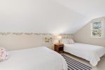 This upstairs bedroom has two queen beds, offering flexible sleeping space for kids, teens, or friends on a Cape Cod vacation.