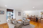 The living and dining space is set up for easy time together, with warm Cape Cod character and room to lounge, eat, and unwind.