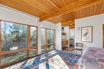 Primary Room with treetop views, built in storage, and natural light, peaceful Wellfleet escape atmosphere.