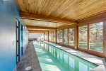 Private indoor lap pool with wall of glass and loungers, rare Wellfleet amenity 