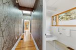 Stylish hallway with skylight and nearby half bath, smart layout for groups staying on Griffins Island.