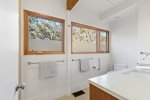 Bright bathroom with wide windows and fresh finishes, simple daily routines during your Wellfleet vacation.