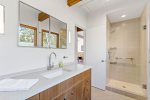 Modern bath with sleek vanity and glass shower, spa style comfort for Cape Cod vacation living.