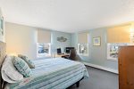 King bedroom with desk workspace and natural light, comfortable sleeping and remote work potential in Eastham.