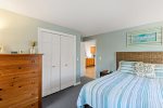 King bedroom with woven headboard and roomy closet, calm coastal styling for restful Cape Cod nights.
