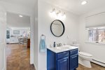 Bathroom vanity with blue cabinets and bright lighting, clean setup for morning starts and evening resets.