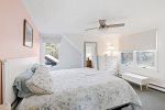 Queen bedroom with soft light and simple coastal comfort, a restful retreat during your Eastham stay.